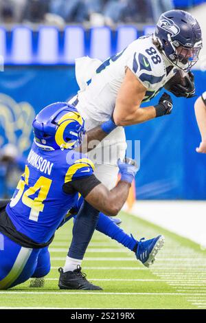 Los Angeles, California, USA. 5th Jan, 2025. Seattle Seahawks tight end AJ Barner #88 is brought down by Los Angeles Rams defensive end Desjuan Johnson #94 during an NFL football game at SoFi Stadium, Sunday Jan. 5, 2025, in Inglewood, Calif. (Credit Image: © Ringo Chiu/ZUMA Press Wire) EDITORIAL USAGE ONLY! Not for Commercial USAGE! Credit: ZUMA Press, Inc./Alamy Live News Stock Photo