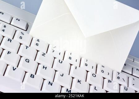 The keyboard of a computer and an envelope. Communication via e-mail, The keyboard of a computer and an envelope. Communication via e-mail. Austria Stock Photo
