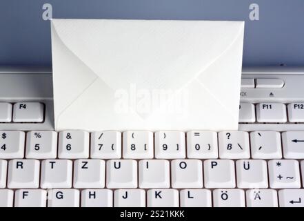 The keyboard of a computer and an envelope. Communication via e-mail, The keyboard of a computer and an envelope. Communication via e-mail. Austria Stock Photo