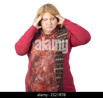 A woman with long blonde hair is holding her head with both hands, expressing stress or a headache. Stock Photo