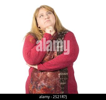 A woman with long blonde hair poses thoughtfully with her hand on her chin, looking upward. Stock Photo