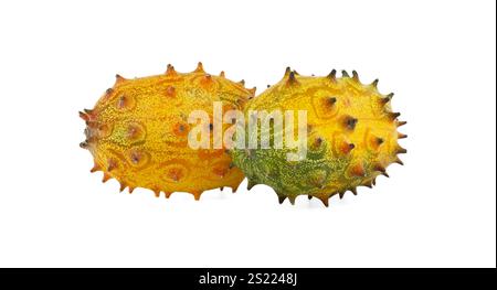Close-up of two ripe horned melons with vibrant orange and green spiky skins on a white backdrop, showcasing their exotic and unique texture Stock Photo