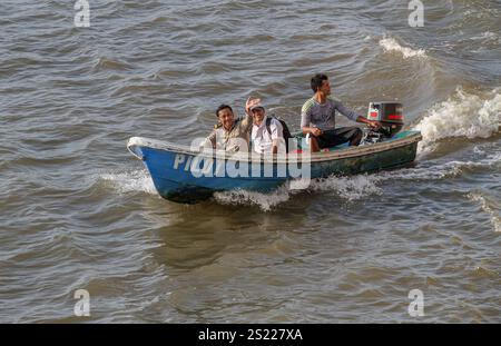 Leuk Daek, Cambodia. Jan 05, 2025: A maritime pilot & a Cambodian customs officer in pilot boat salute the ship they inspected & helped navigate the Mekong River, one of the longest rivers in Asia & a vital trade route for the Cambodian kingdom. At least as long the Funan Techo canal is under construction (Tonle Bassac Navigation Road & Logistics System Project), a $1.7B China-backed project to connect Phnom Penh to the sea. This megaproject will shift a large share of the import/export trade transiting Vietnam's Mekong River Delta to Cambodia's seaports. Credit: Kevin Izorce/Ģ����ý Live News Stock Photo