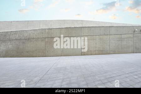Empty concrete floor and wall under blue sky with clouds in modern city Stock Photo