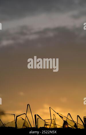 Sunset behind the broken glass. Stock Photo
