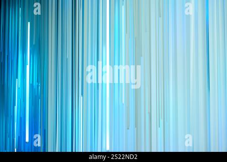Light blue vertical stripes hanging and creating a modern abstract background Stock Photo