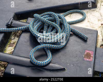 Coiled blue and white striped rope on the deck of a narrowboat, UK Stock Photo