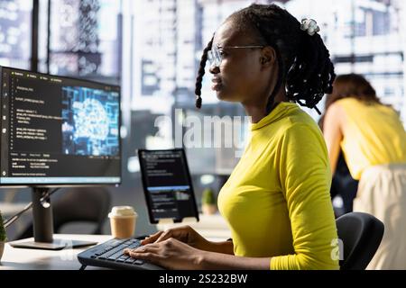 Worker conducting code review to fix bugs, identifying performance and technical issues with artificial intelligence company software. Woman debugging and optimizing code using AI Stock Photo