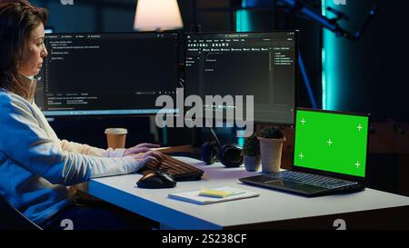 Programmer using green screen laptop to secure company servers from virus attacks. IT remote employee writing code, building firewalls protecting data using mockup notebook, camera A Stock Photo