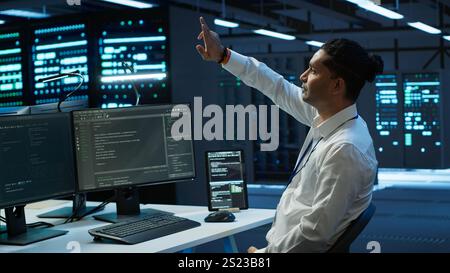 Admin in data center using augmented reality technology to ensure system can handle networking tasks. Server room worker looking at AR visualization hologram, tracking network traffic, camera A Stock Photo