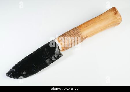 Stone Age Knife with Bone Handle and Obsidian Blade isolated on white Background Stock Photo