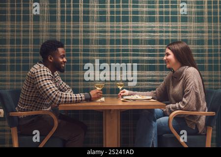 Young couple having romantic dinner on their first date. Stock Photo