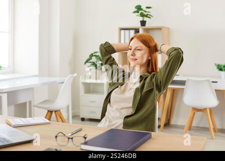 Happy Woman Relaxing While Working Online From Home Office Stock Photo