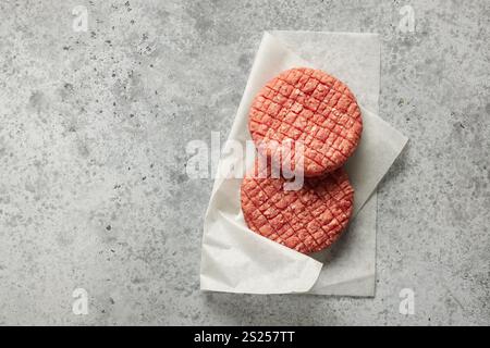 fresh raw burger meat on grey kitchen table, top view Stock Photo