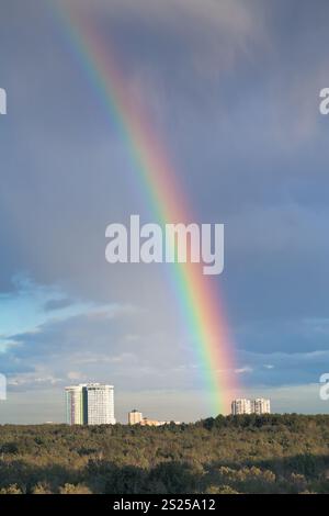 urban house under rainbow in dark blue sky Stock Photo