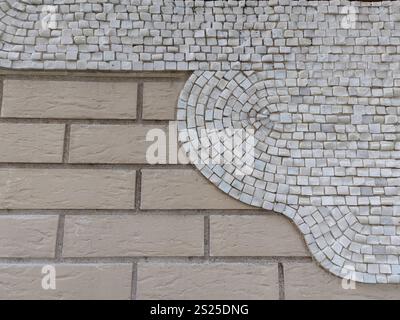 A minimalistic mosaic design featuring white tiles in a semi-circular pattern against a beige brick wall. The smooth gradient adds a modern, elegant Stock Photo