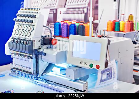 Embroidery industrial machine in sewing workshop Stock Photo