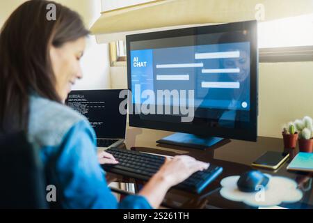 AI chat bot, Programmer using generative artificial intelligence for interface development on computer, Virtual chatBot technology trend Stock Photo