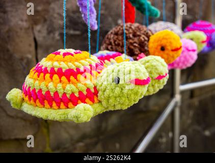 Sochi, Russia - March 19, 2024: Toy turtles knitted from thick multi-colored threads Stock Photo