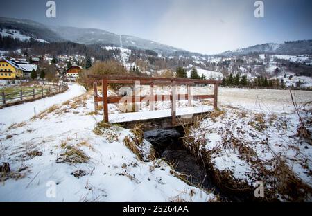 Beautiful view of old wooden bridge over river in Austrian Alps Stock Photo