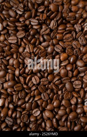 Top view closeup roasted coffee beans. Vertical copy space background, cover, backdrop, texture. Place for adding text or design Stock Photo