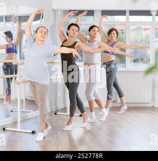 Group of women beginners practicing at ballet barre Stock Photo