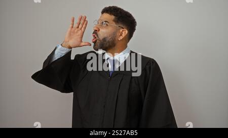 Young man in graduation gown with glasses calls out isolated on white background Stock Photo