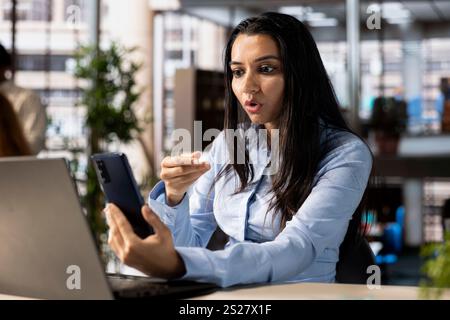 Professional indian worker leads a teleconference with team members, discussing project details and strategic objectives. Virtual meeting ensures efficient business communication across locations. Stock Photo