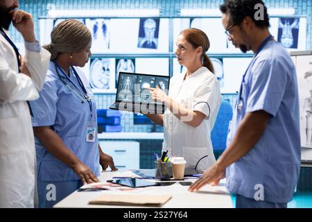 Medical team collaborates on diagnostic procedures and treatment plans. Professionals in radiology and radiography support accurate diagnosis and effective disease prevention, insurance. Stock Photo