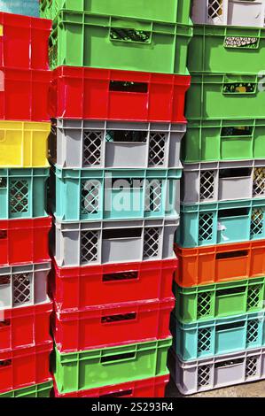Colourful plastic crates are waiting to be transported away. Logistics and packaging Stock Photo