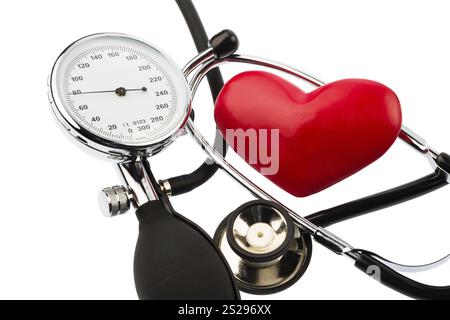 A sphygmomanometer, a heart and a stethoscope lie on a white background Austria Stock Photo