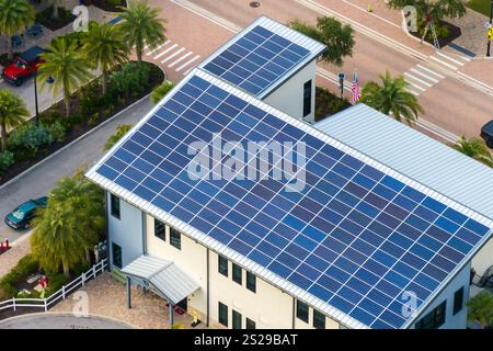 Solar photovoltaic panels installed on top of Florida office building for producing clean ecological electric energy. Renewable electricity with zero Stock Photo