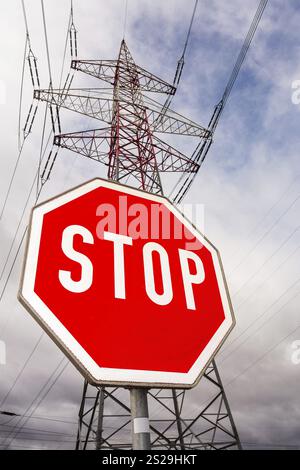 A pylon of a power line and a stop sign. Symbolic photo for phasing out nuclear energy Austria Stock Photo