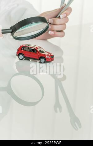 Car is examined by a doctor. Costs for maintenance and repair Stock Photo