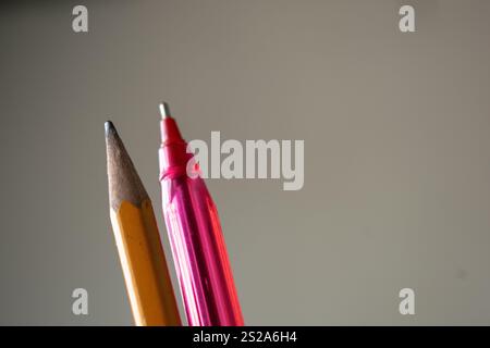 A close-up of a pencil and pen placed in focus against a blurred background, highlighting precision and simplicity. This image is perfect for projects related to education, office work, stationery, and creativity. Suitable for use in advertisements, academic materials, and professional presentations Stock Photo