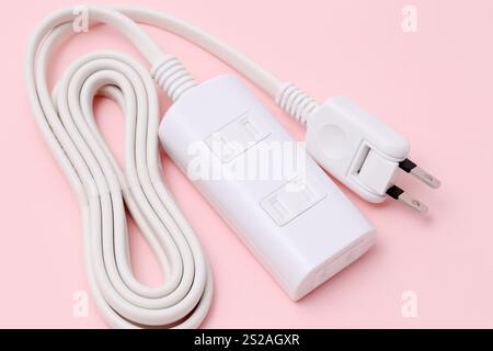 close up of extension cord on a pink background Stock Photo