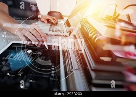 creative working with mobile phone and digital tablet and stylus pen on wooden desk in modern office with virtual icon diagram Stock Photo