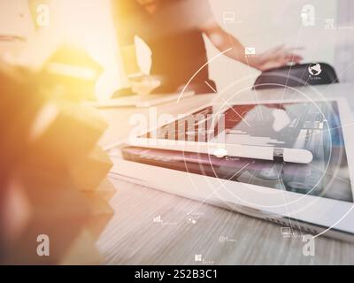 creative working with mobile phone and digital tablet and stylus pen on wooden desk in modern office with virtual icon diagram Stock Photo