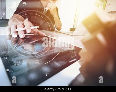 creative working with mobile phone and digital tablet and stylus pen on wooden desk in modern office with virtual icon diagram Stock Photo