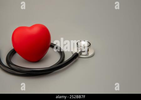 A red heart and a stethoscope. Copy space for text. Healthcare, health, and heart health concept. Stock Photo