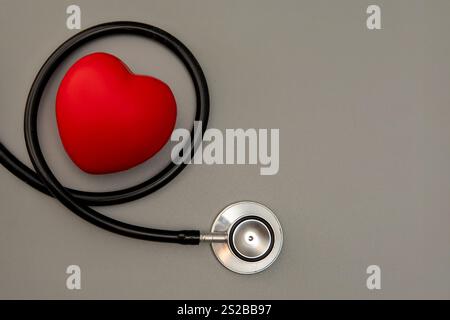 Top view image of a red heart and a stethoscope. Copy space for text. Healthcare and medical concept. Stock Photo