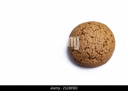 A single round oatmeal cookie placed on a clean white background, showcasing its golden-brown texture and rustic charm Stock Photo