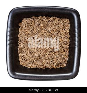 top view of caraway seeds in black bowl isolated on white background Stock Photo