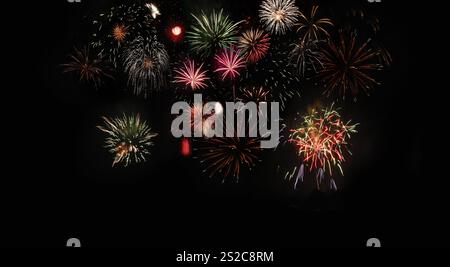 A vibrant display of fireworks exploding across the night sky. Stock Photo