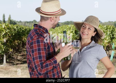 young couple tasting wine in vineyard Stock Photo