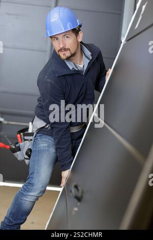 man builder is holding a door Stock Photo