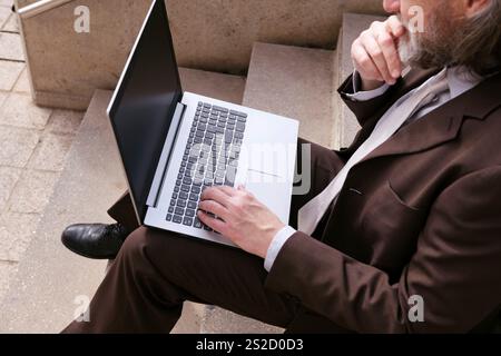 unrecognizable male working online on laptop Stock Photo