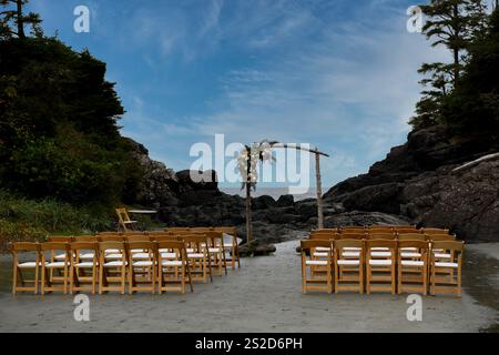Rear view of wooden chairs lined up on a beach ready for a wedding, Canada Stock Photo