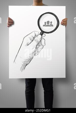 man showing poster of drawing of hand holding magnifier glass looking for employee as concept Stock Photo