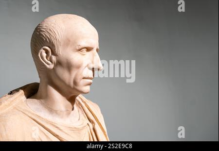 Profile of bald bust of ancient roman senior man sculpted in marble Stock Photo